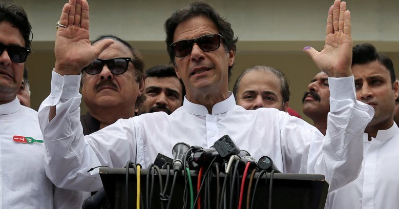 Imran Khan speaks to members of media after casting his vote at a polling station during the general election in Islamabad